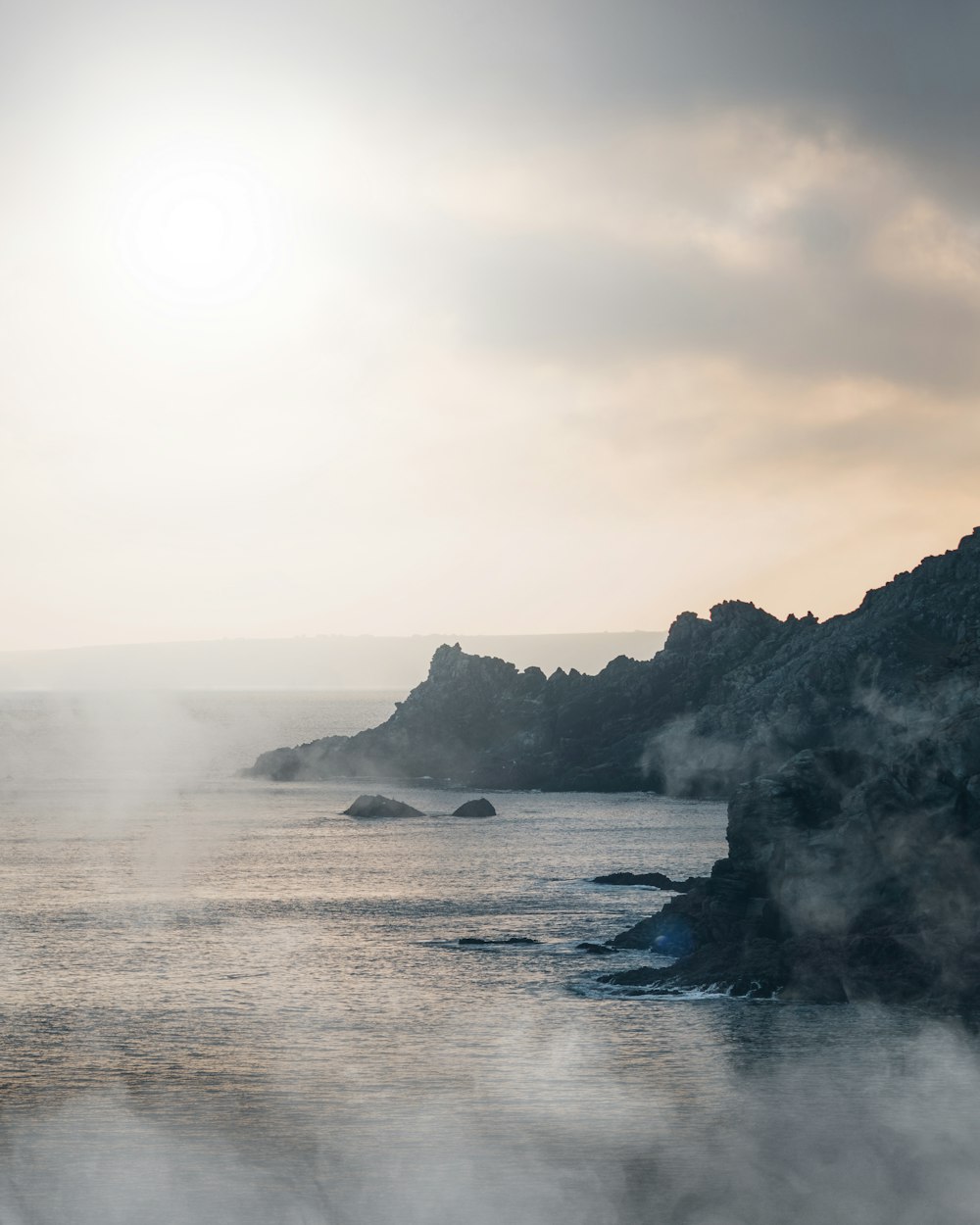 a body of water with steam rising from it