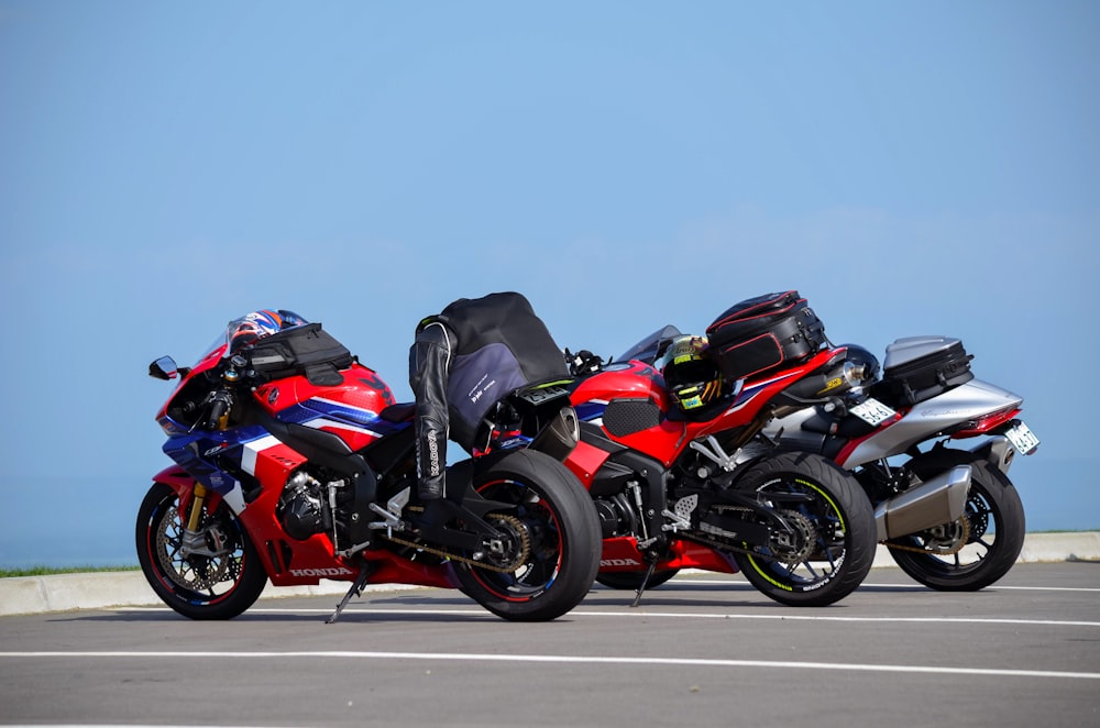 three motorcycles parked next to each other in a parking lot