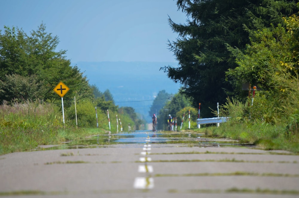 a road with a yellow sign on the side of it