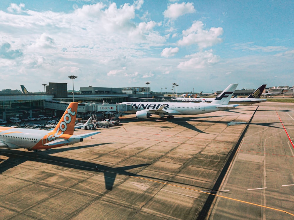 a couple of airplanes that are on a runway