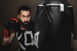 a man with a beard wearing boxing gloves