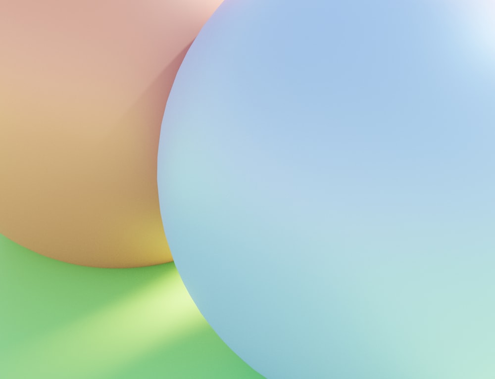 a close up of two balloons on a green and yellow background