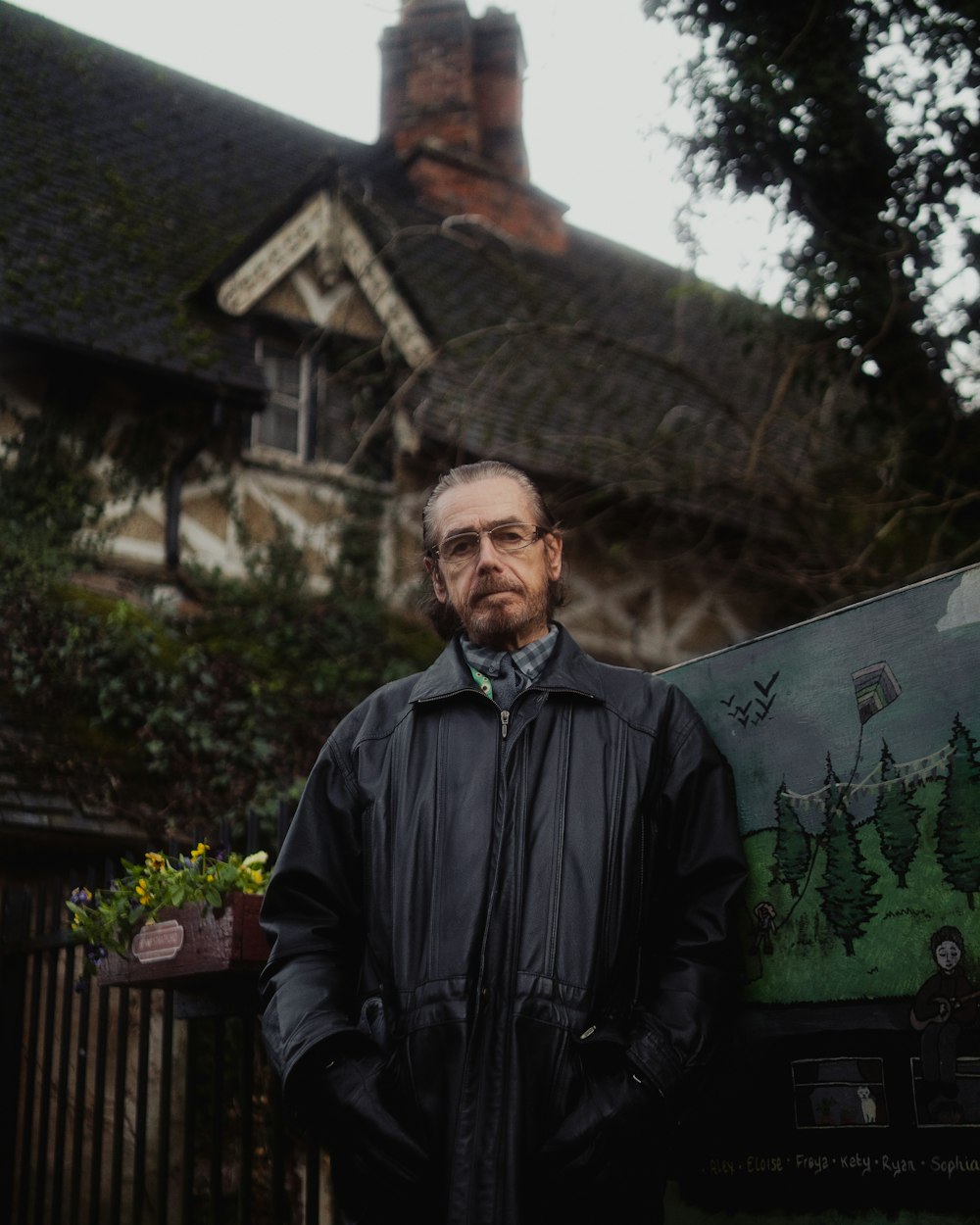 a man standing in front of a house