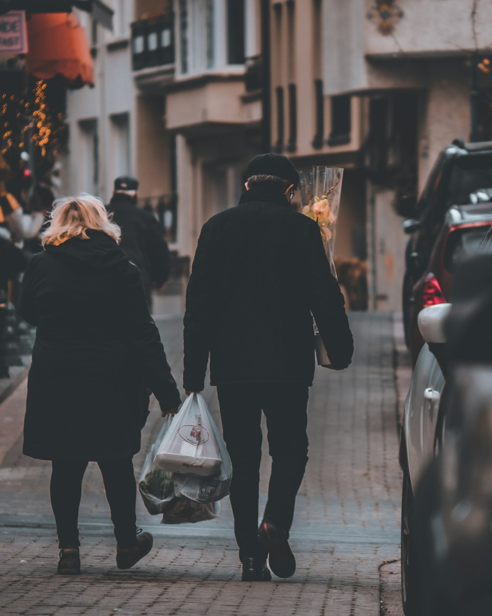 a man and a woman walking down a street