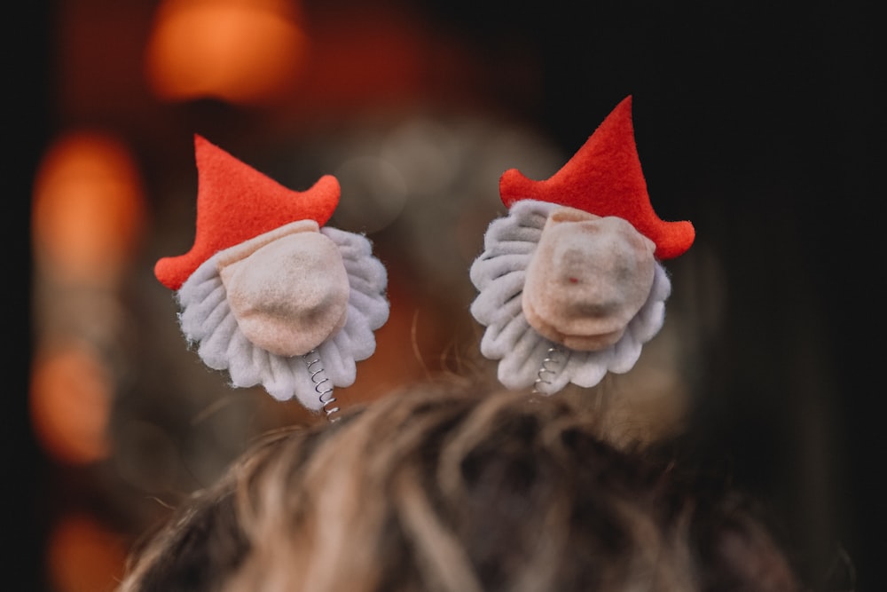 a close up of two red and white hair clips