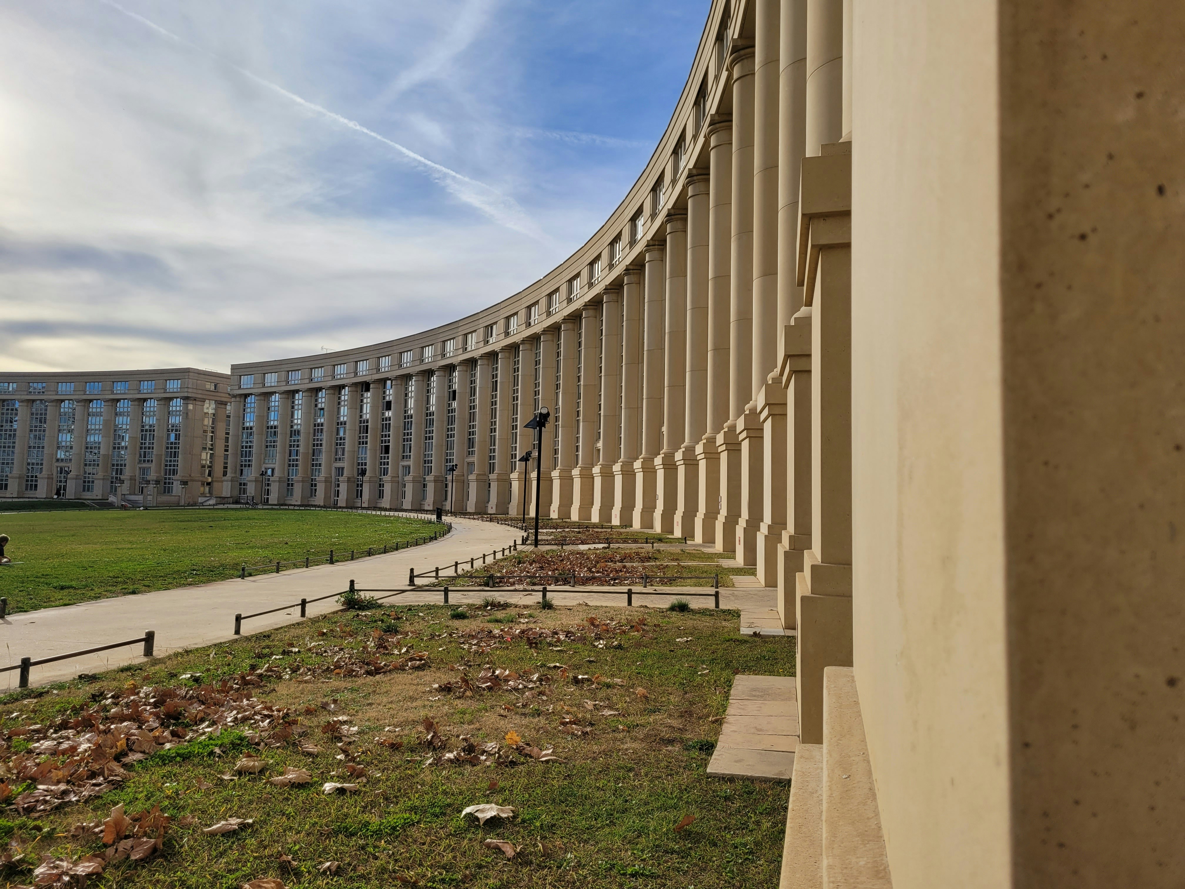a large building with a curved walkway in front of it
