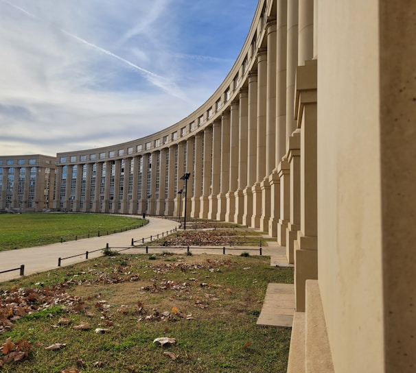 a large building with a curved walkway in front of it