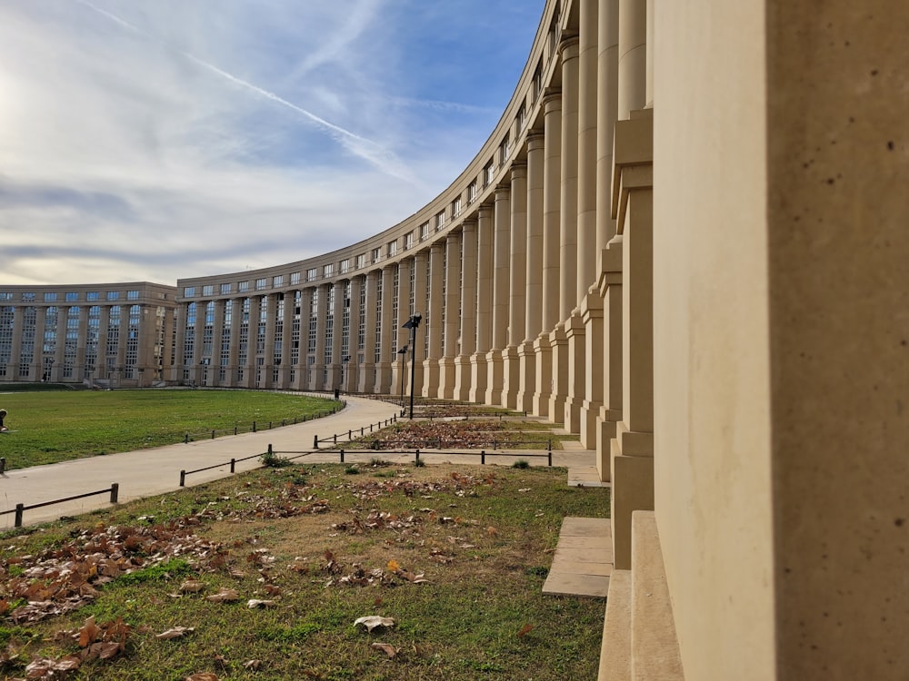 a large building with a curved walkway in front of it