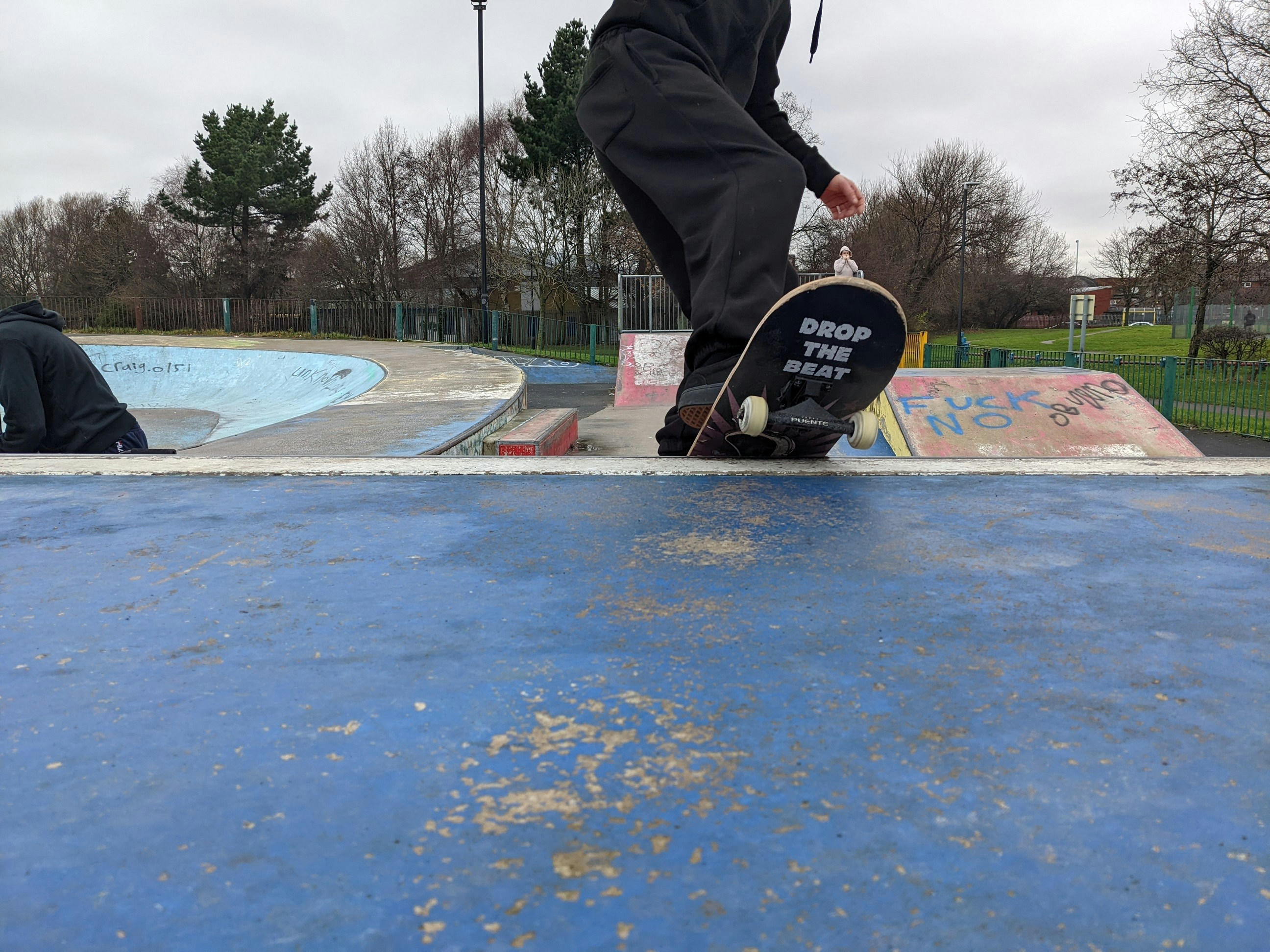 a man riding a skateboard on top of a blue ramp