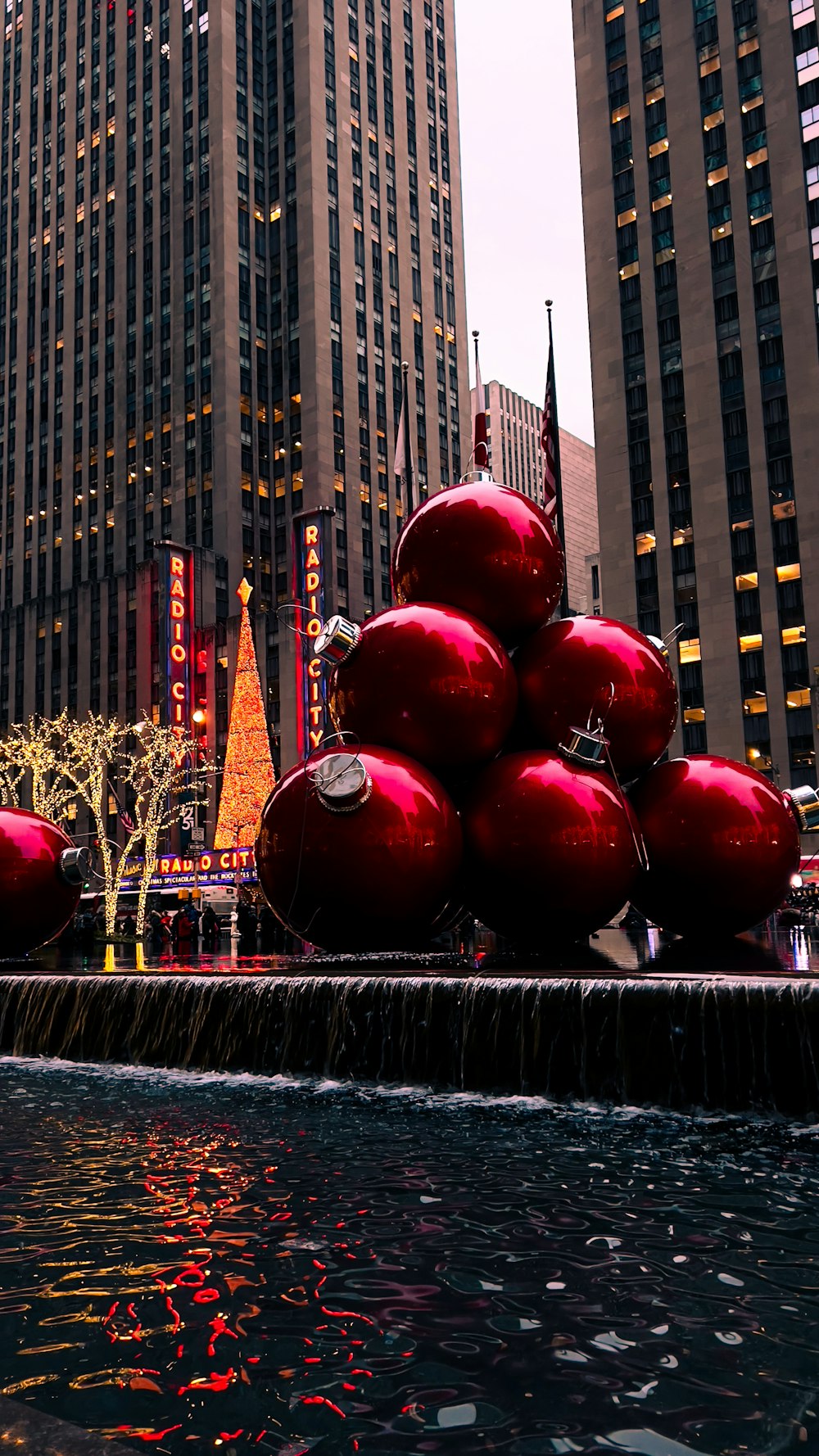 a group of red balls sitting on top of a fountain