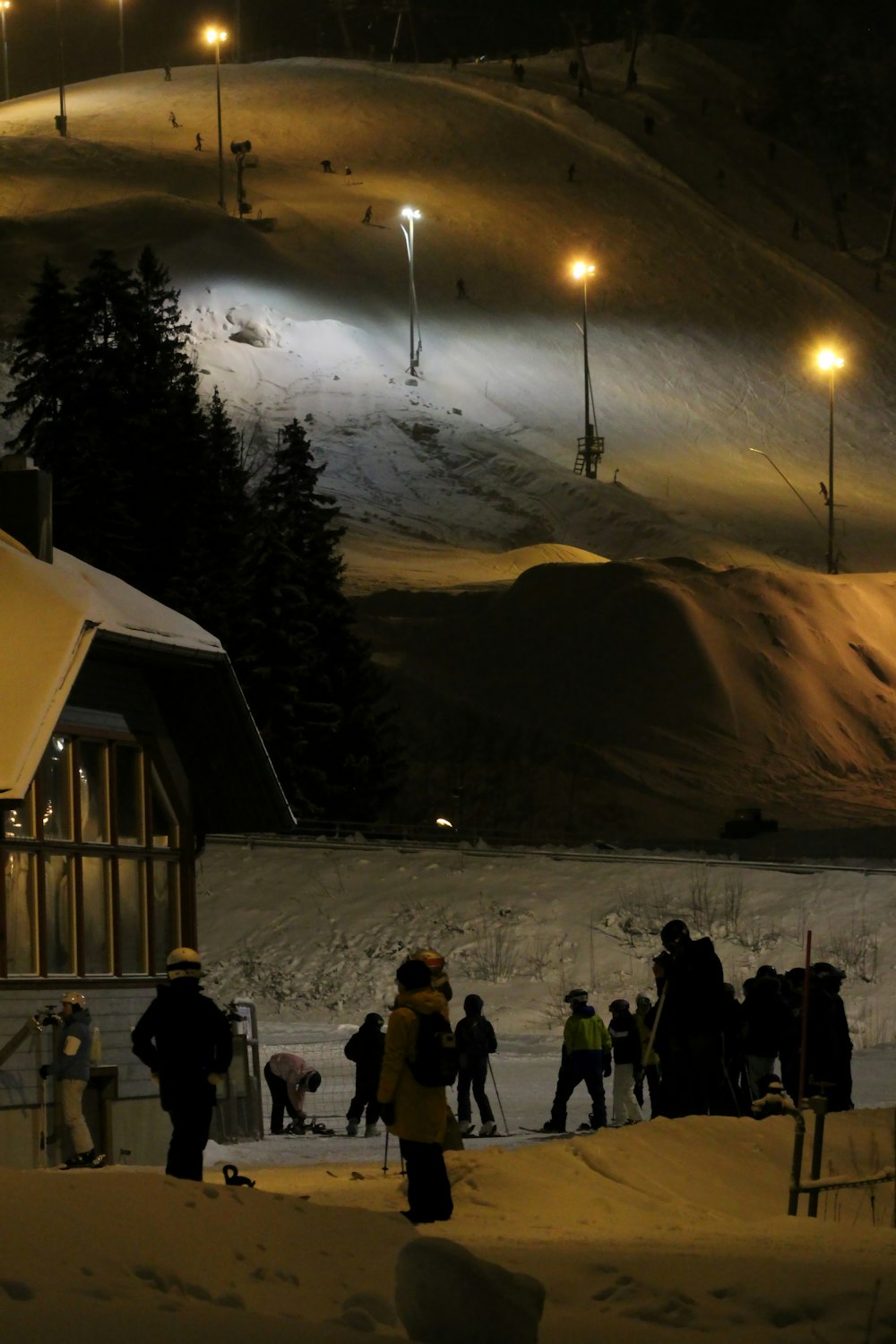 a group of people standing on top of a snow covered slope