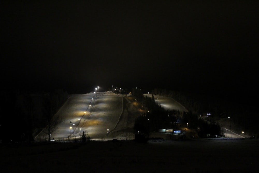 a ski slope lit up at night in the dark