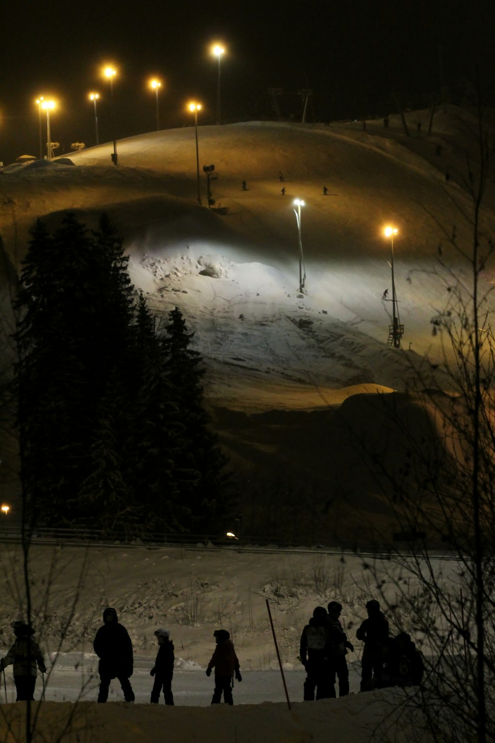 a group of people standing on top of a snow covered slope