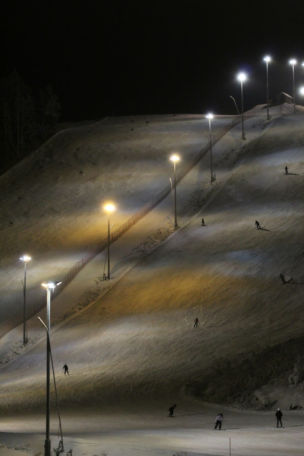 a group of people skiing down a snow covered slope