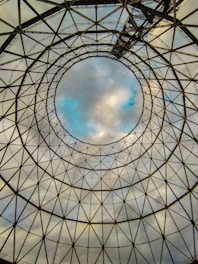 a circular structure with a sky in the background
