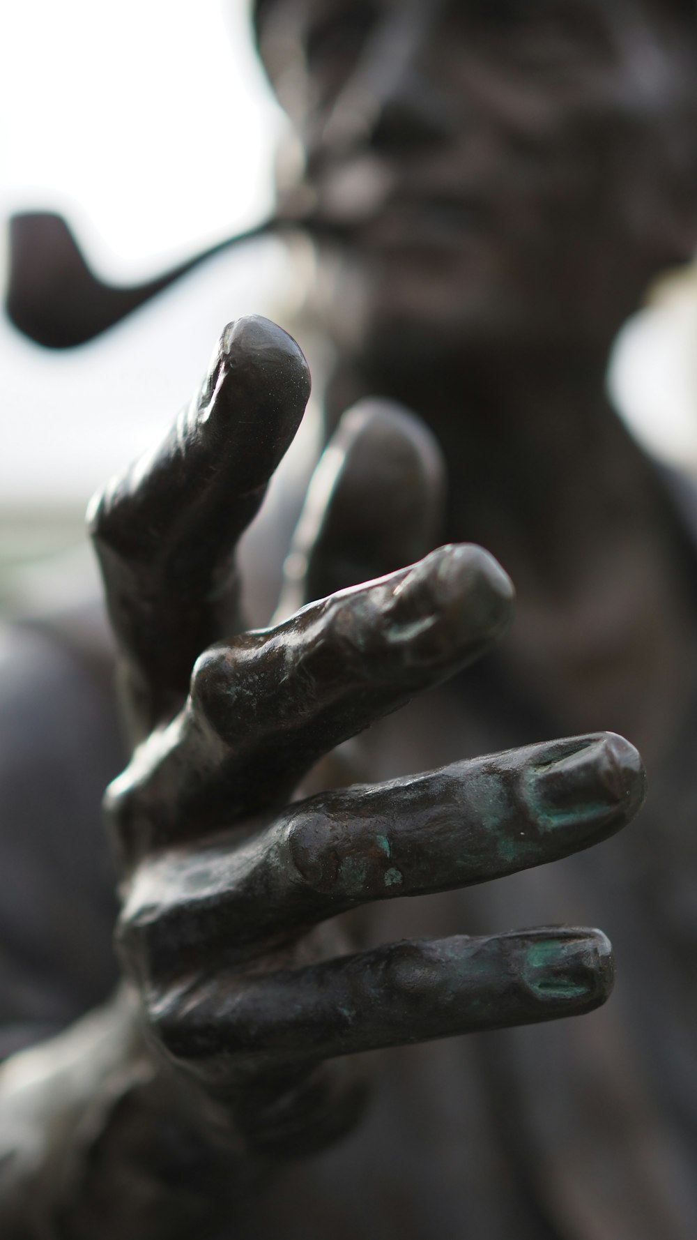 a close up of a statue of a person holding a cell phone