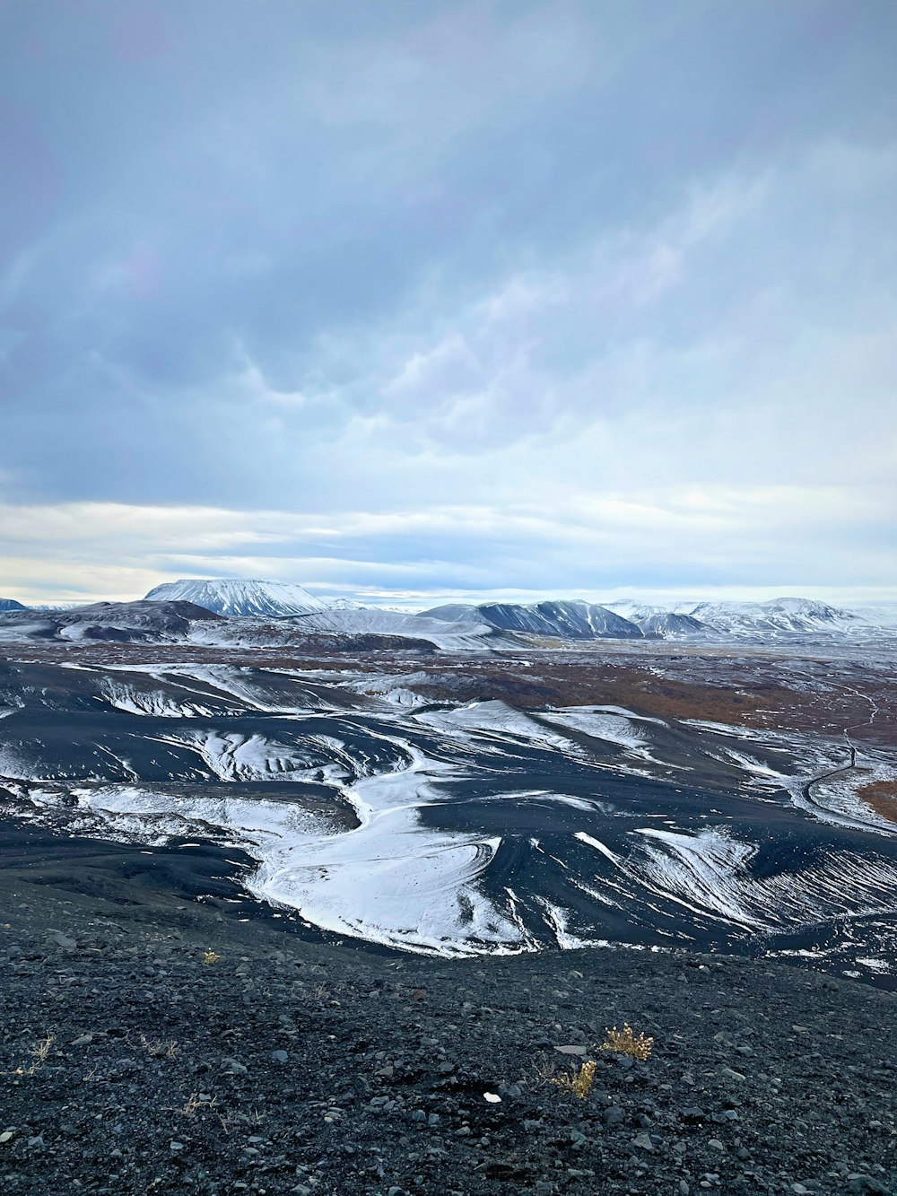 a snowy landscape with mountains in the background