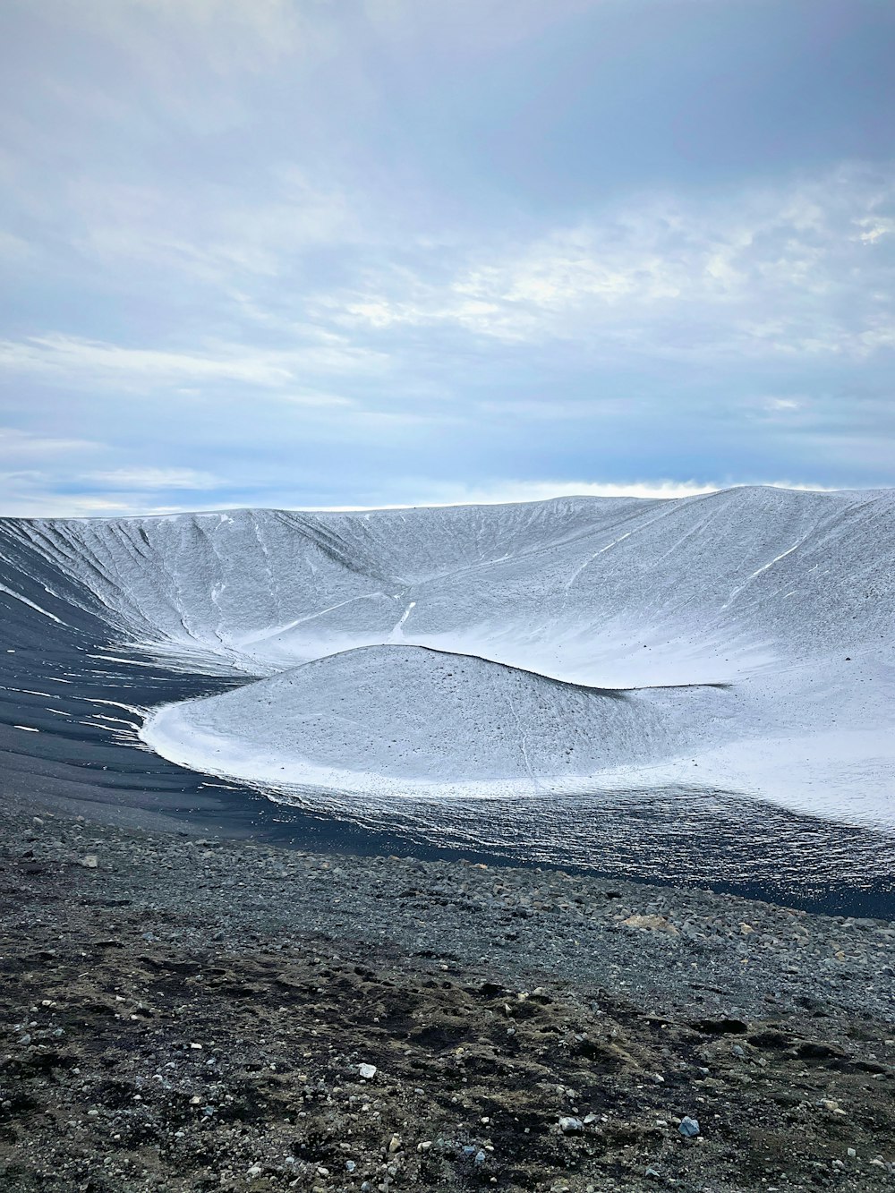 a snowy landscape with a mountain in the background