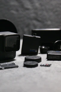 A collection of media accessories including headphones, memory cards, and tripods.