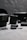 A collection of camera equipment including action cameras, battery packs, and memory cards is arranged on a grey textured surface. The foreground features a prominent action camera and memory card, with additional equipment blurred in the background.