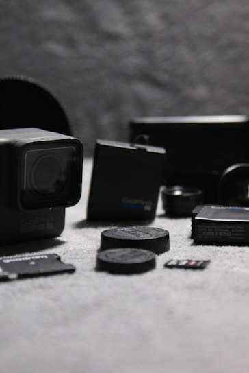 A vibrant display of various GoPro cameras and mounts arranged on a wooden table, ready for action.