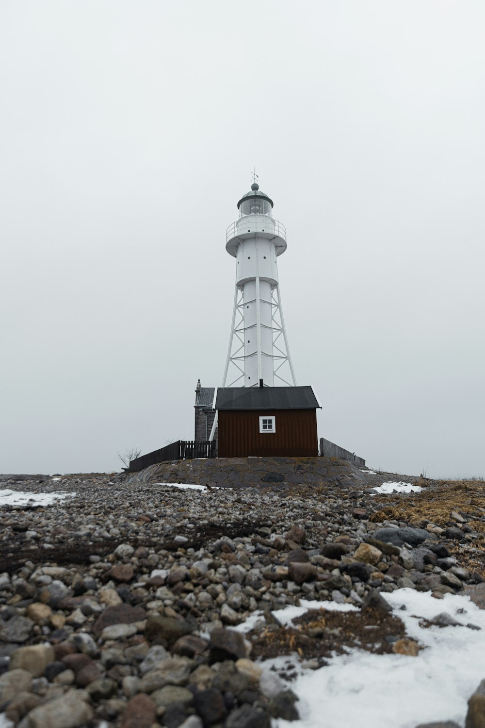 a light house sitting on top of a rocky beach