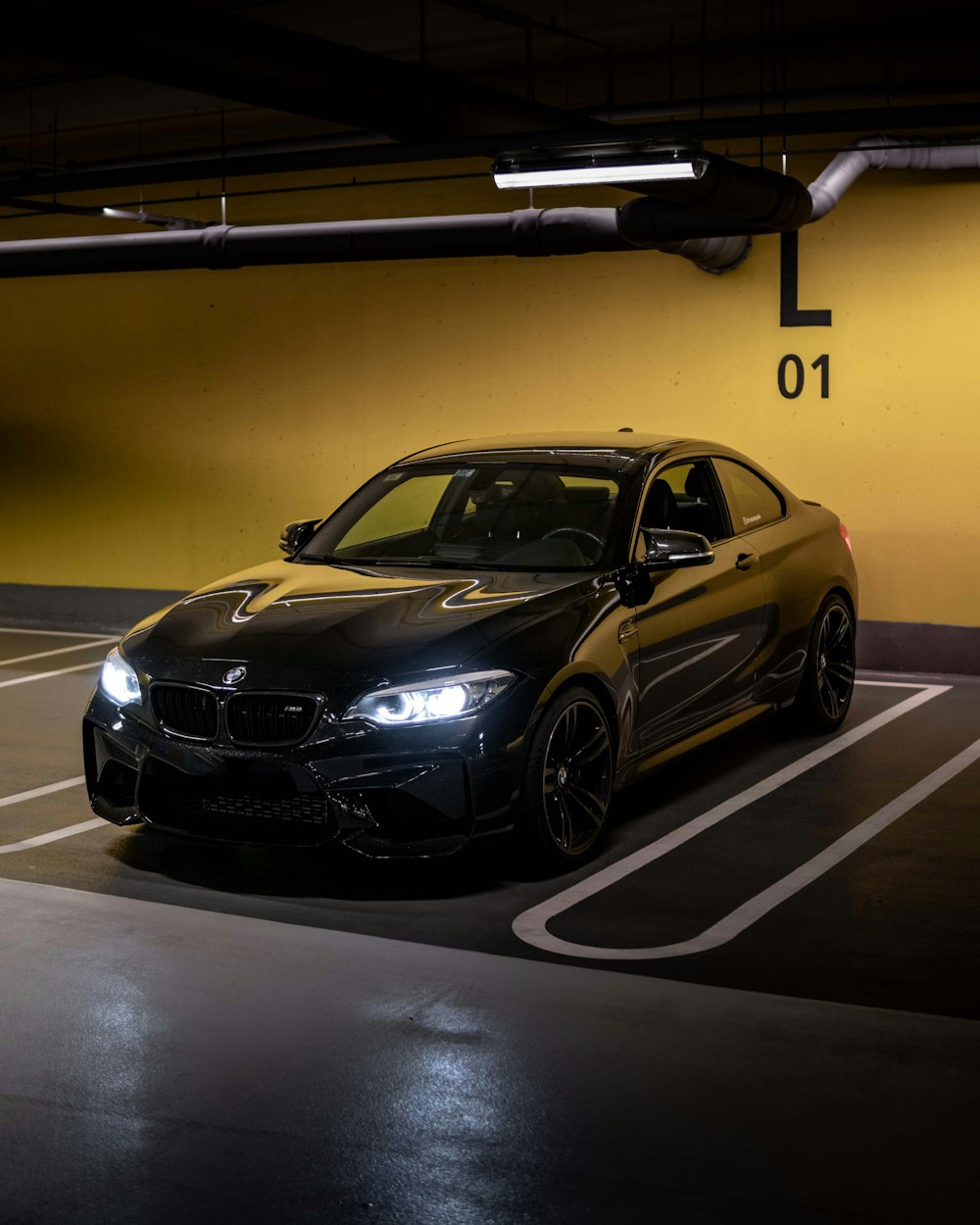 a black car parked in a parking garage