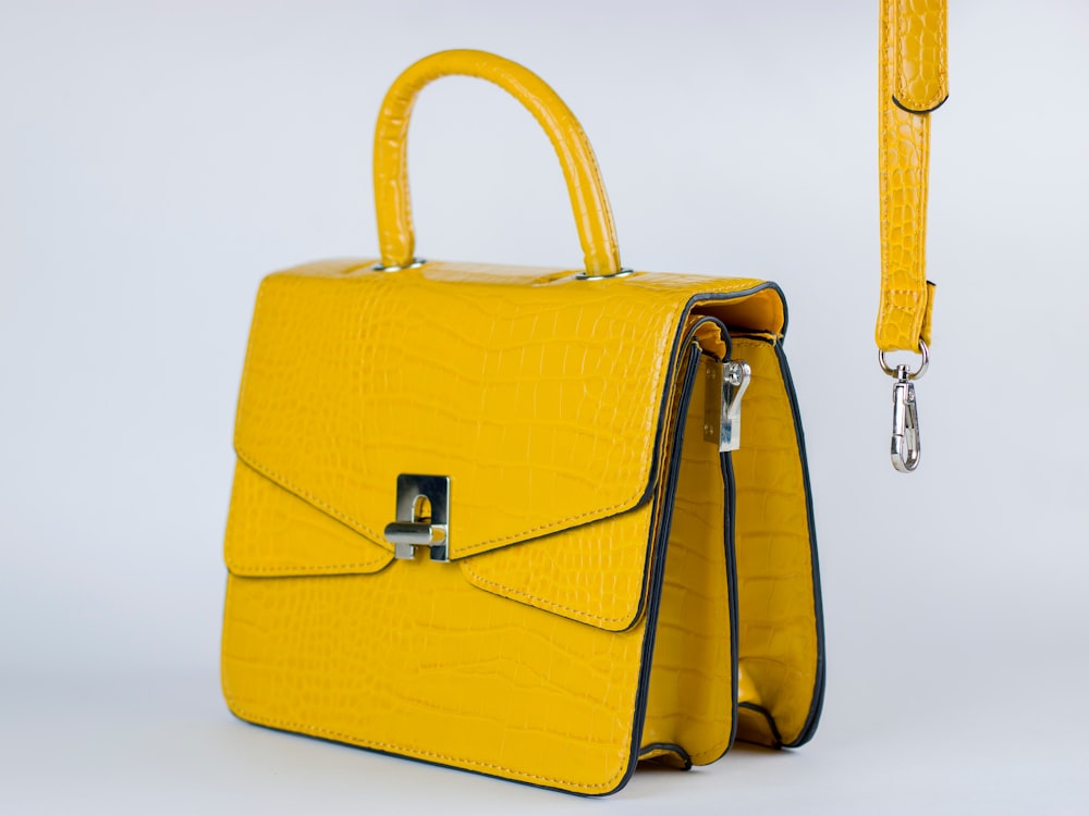 a yellow handbag with a long strap