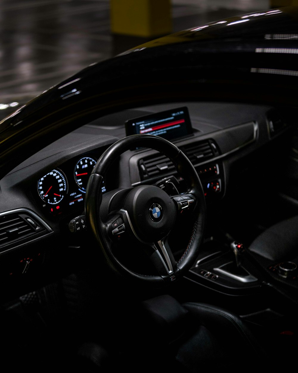 the interior of a car with a steering wheel and dashboard