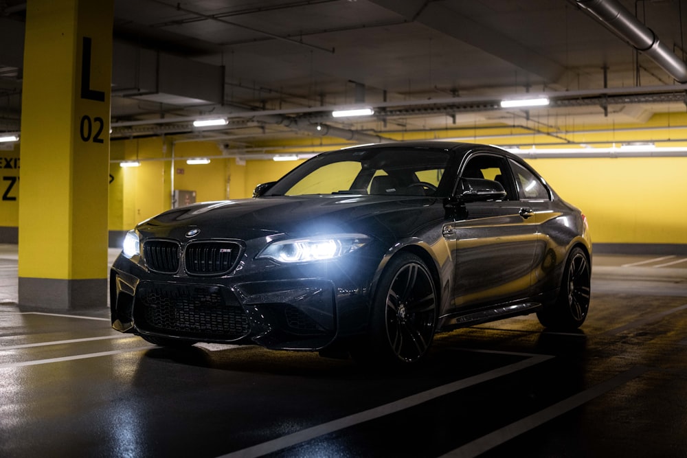 a black car parked in a parking garage