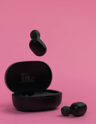 A vibrant display of wireless earbuds with charging case on a clean surface.