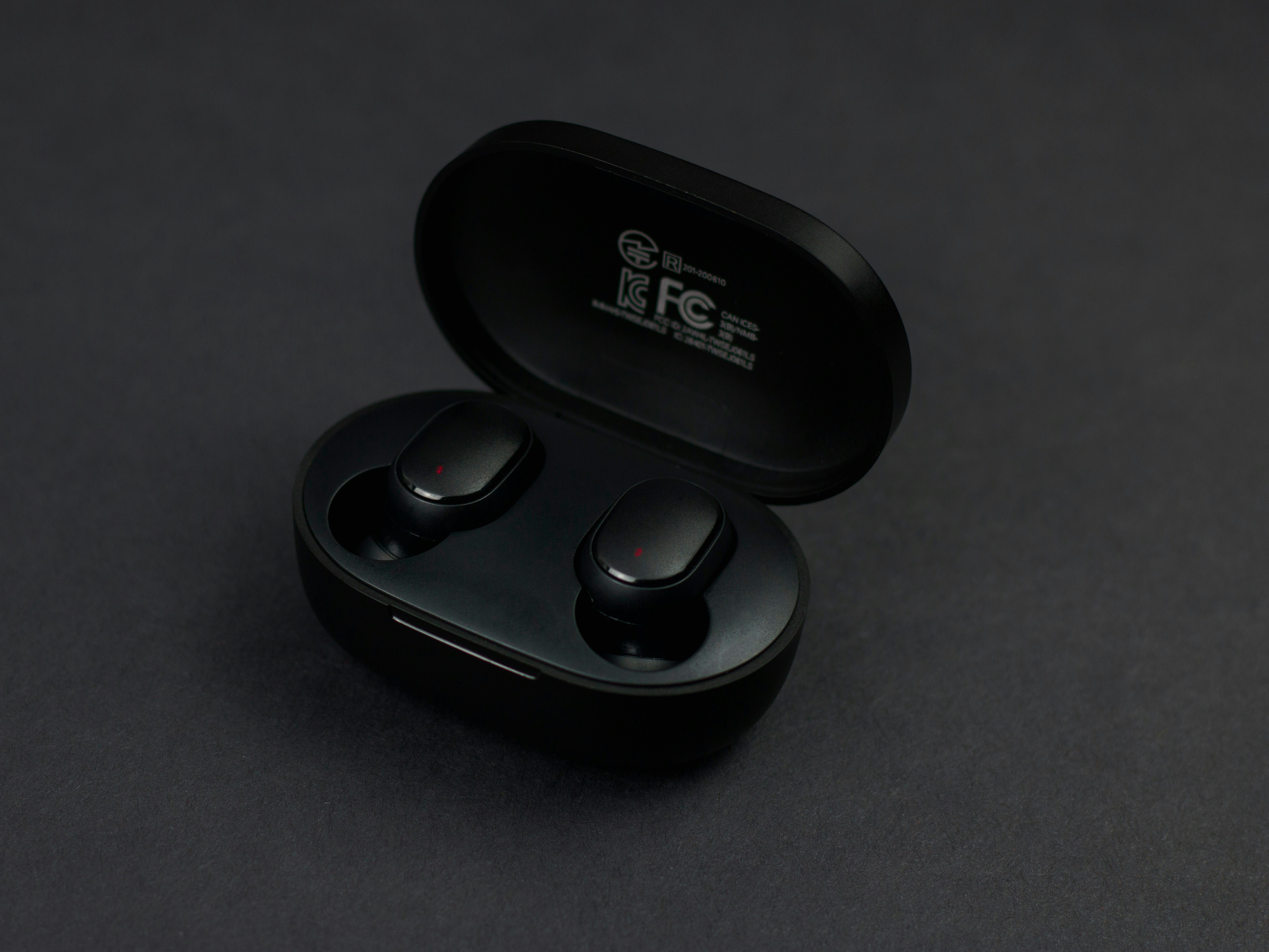a pair of black earbuds sitting on top of a table