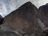Team of researchers documenting petroglyphs on a rocky surface
