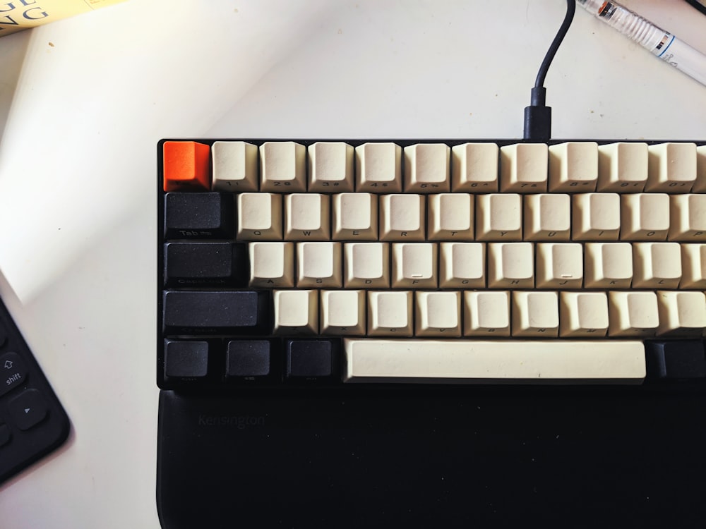 a computer keyboard sitting on top of a desk