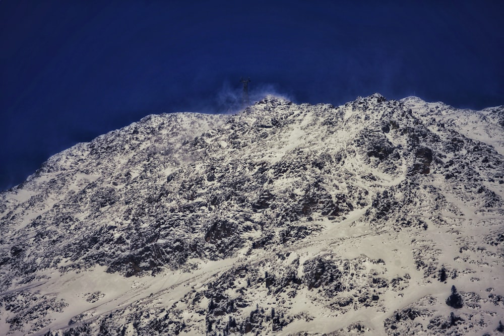 a mountain covered in snow under a blue sky