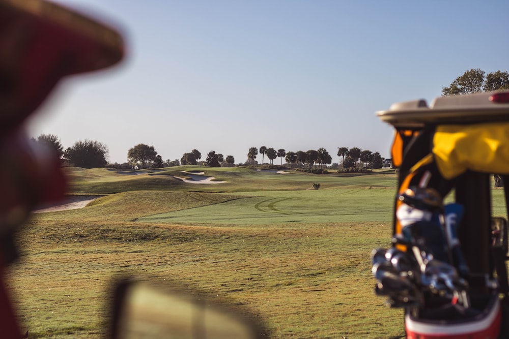 a view of a golf course from the driver's seat of a golf cart