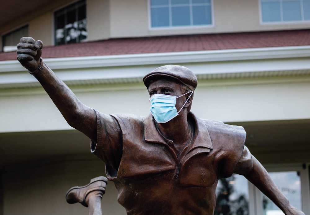 a statue of a man wearing a face mask
