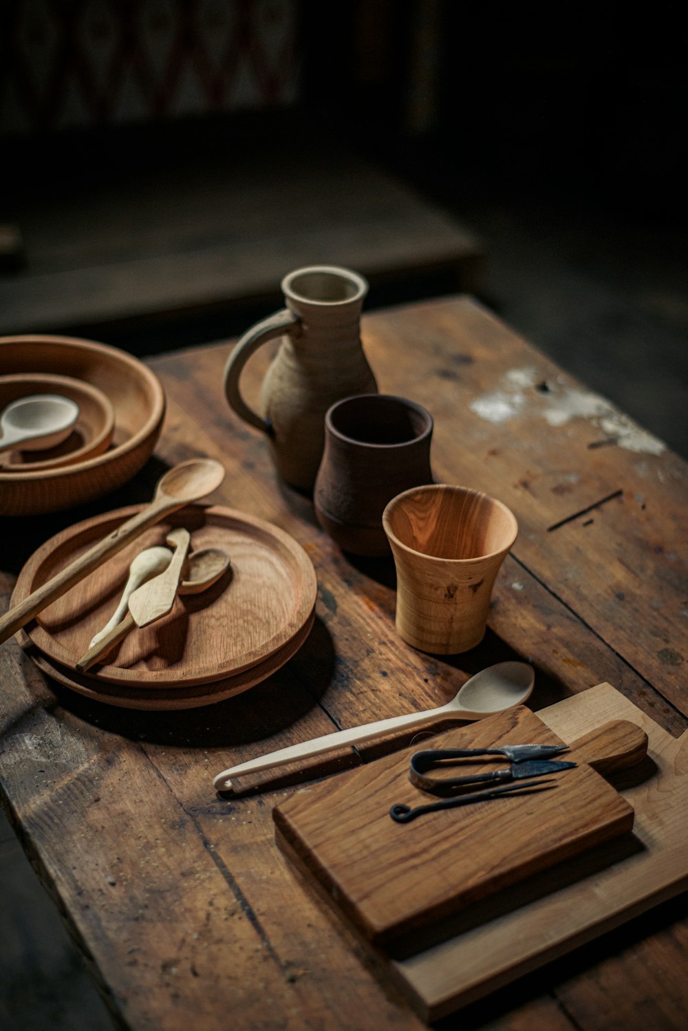 a wooden table topped with dishes and cups