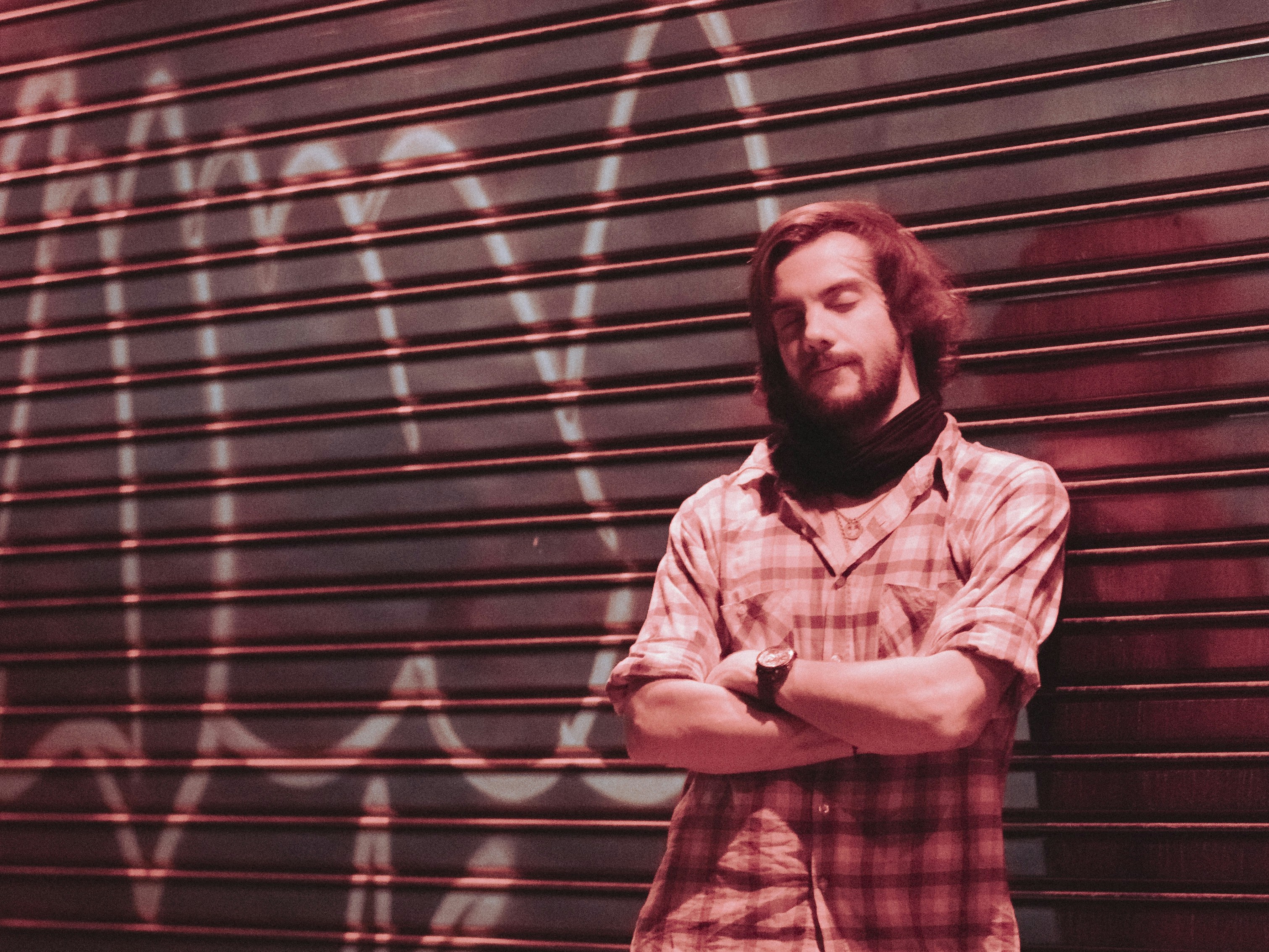 a man standing in front of a graffiti covered wall