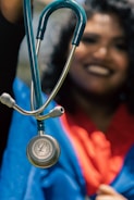 a woman holding a stethoscope up to her face