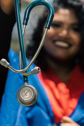 a woman holding a stethoscope up to her face