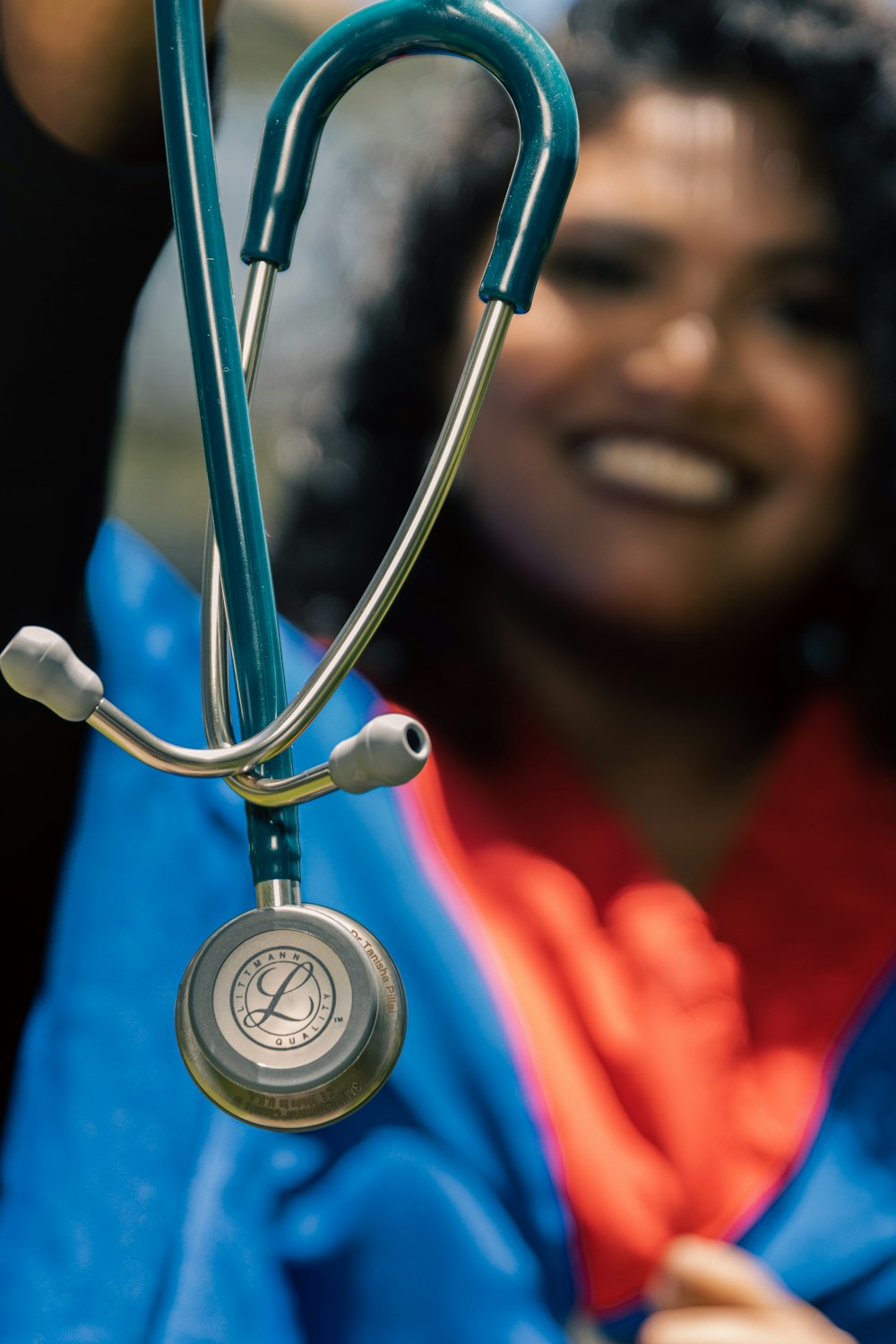 a woman holding a stethoscope up to her face