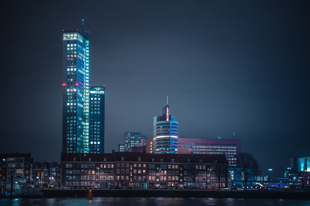 a city skyline at night with buildings lit up