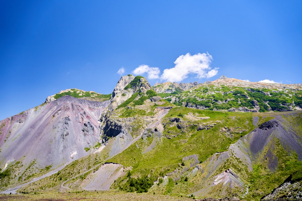 a view of a mountain range with a cloud in the sky