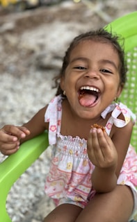 A cheerful child sitting in a dental chair, smiling.