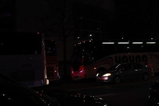 A fleet of various vehicles parked in a well-lit area, ready for passengers.