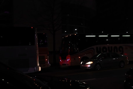 A fleet of various vehicles parked in a well-lit area, ready for passengers.