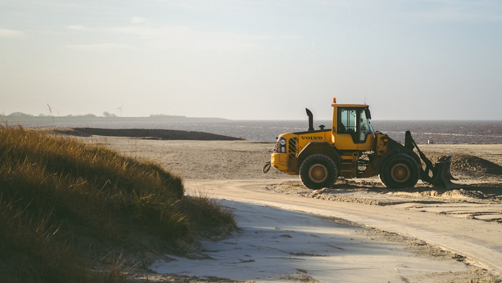 a bulldozer is parked on a dirt road