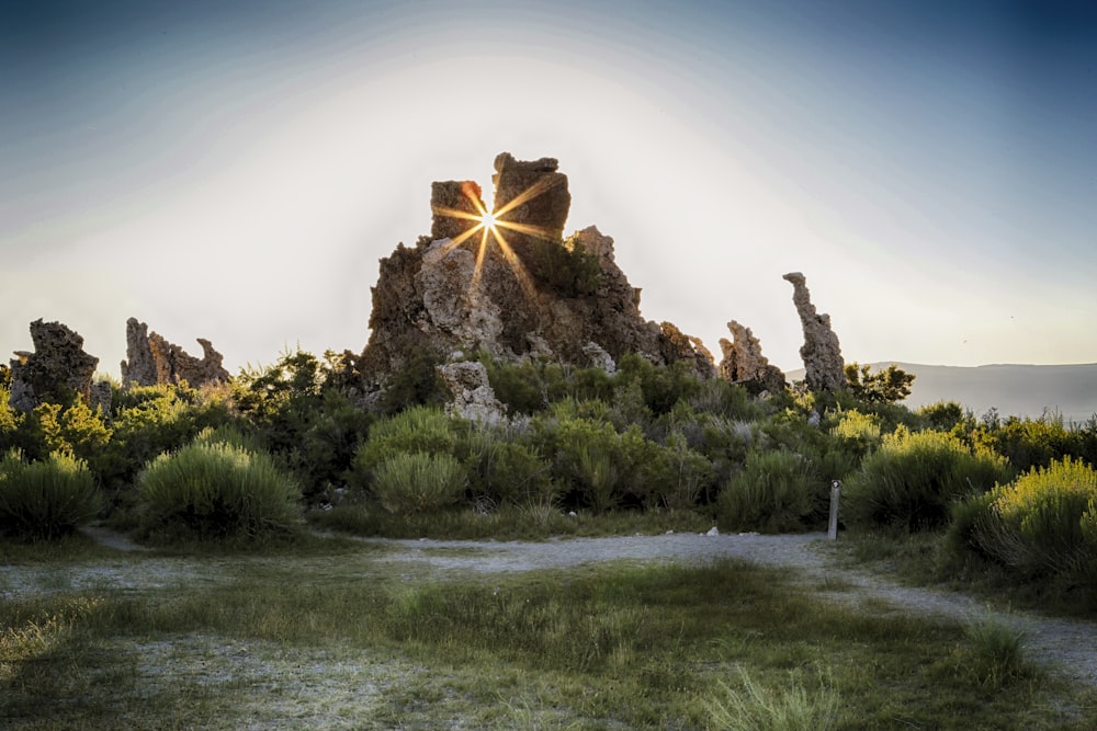 the sun shines brightly on a rocky outcropping