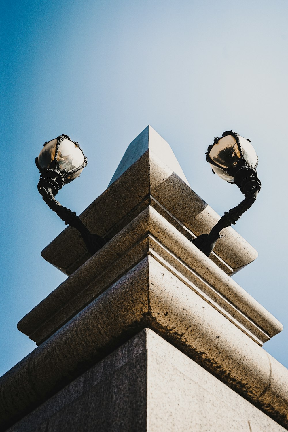 a tall building with two lamps on top of it